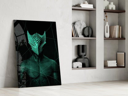 Darko Green Glass Wall Art leaning against white wall beside shelving unit, displaying neon turquoise geometric mask on black background.
