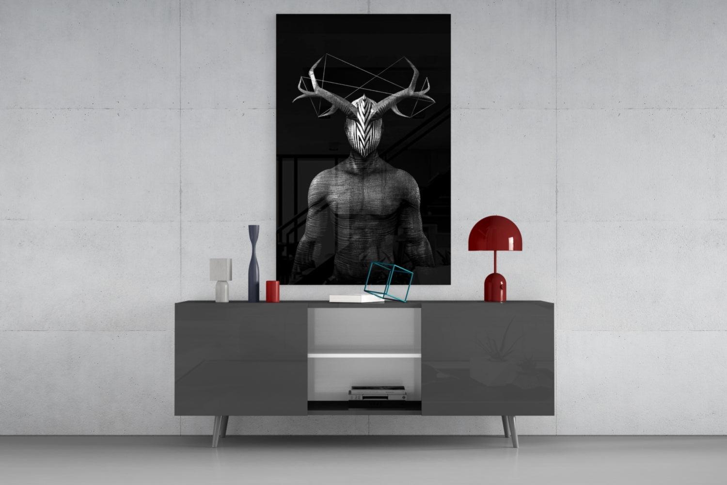 Black and white glass wall art depicting muscular figure with large antlers, displayed above gray console table with red lamp and decorative objects.