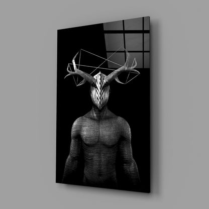 Black and white glass wall art depicting a muscular humanoid figure with an ornate deer skull head and geometric antler shapes, displayed at an angle.