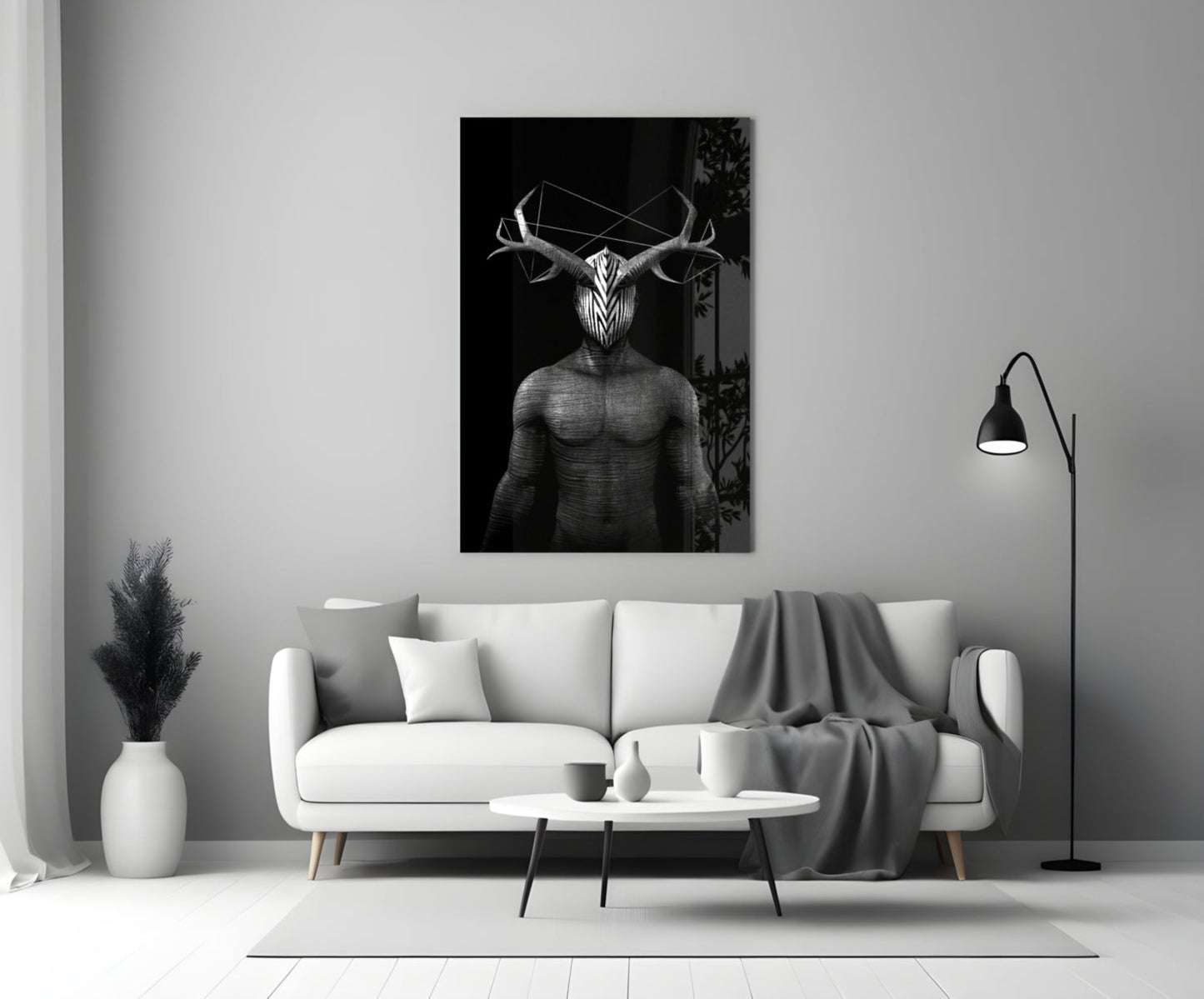 Black and white glass wall art depicting a geometric deer figure with antlers displayed above a white sofa in a modern living room.