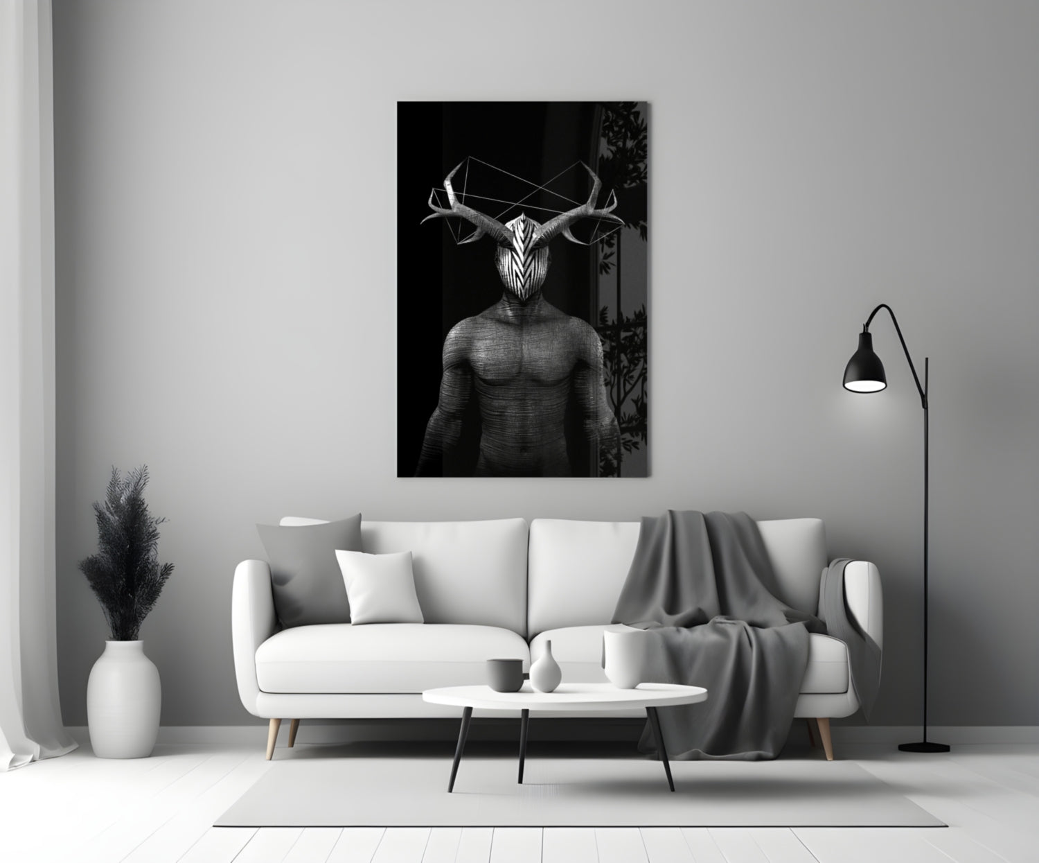 Black and white glass wall art depicting a geometric deer figure with antlers displayed above a white sofa in a modern living room.