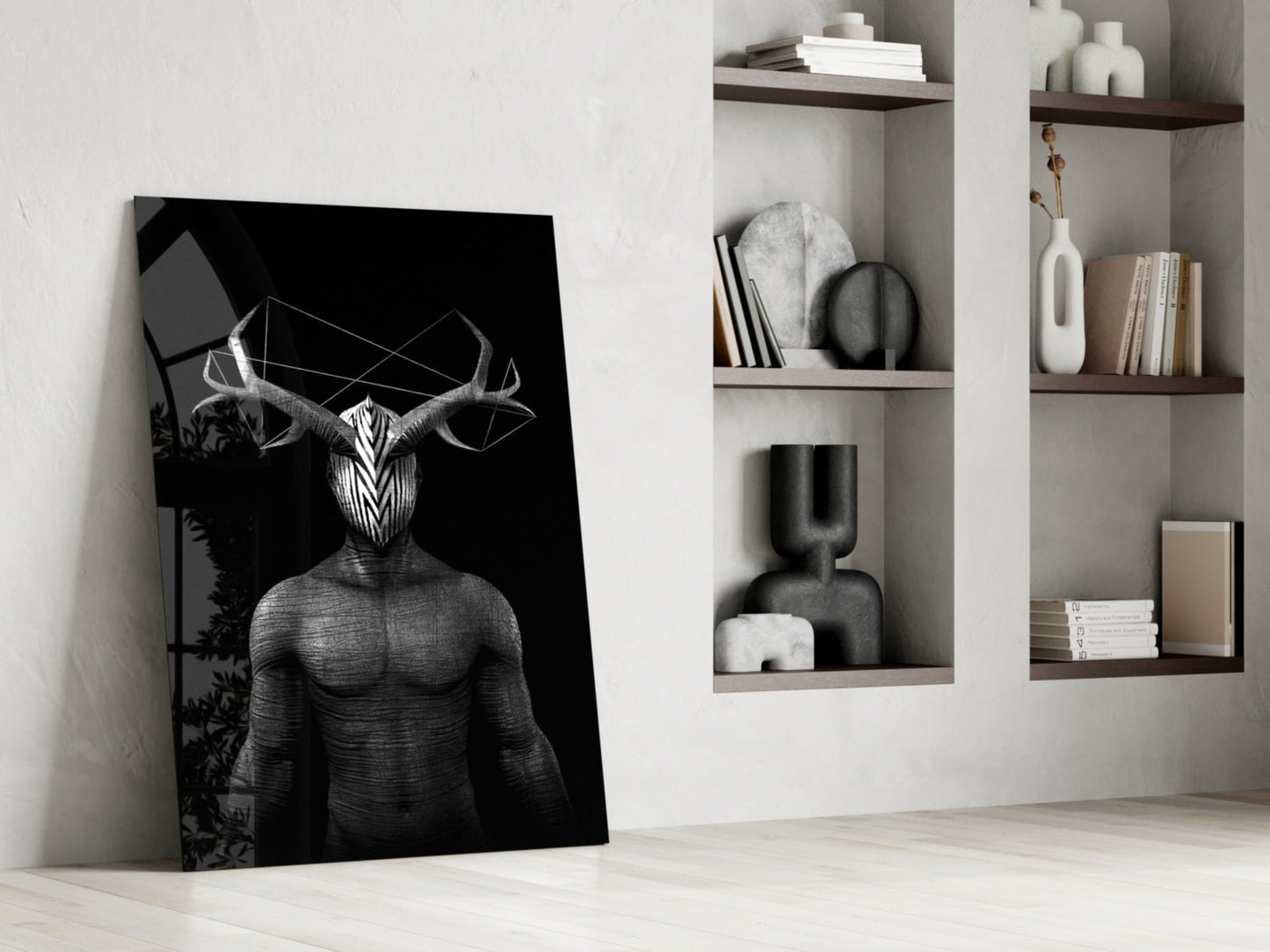 Black and white glass art depicting surreal horned figure leaning against white wall near shelving unit with books and decorative objects.