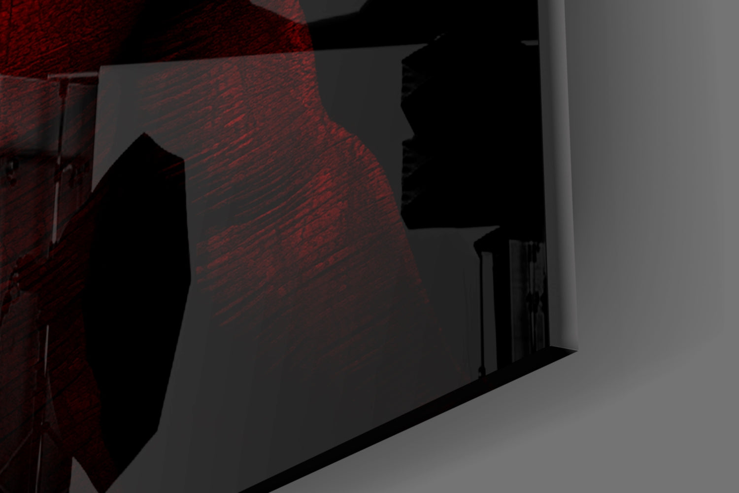 Red textured glass wall panel mounted on white wall with black shadow cast across its surface, shown at angle.
