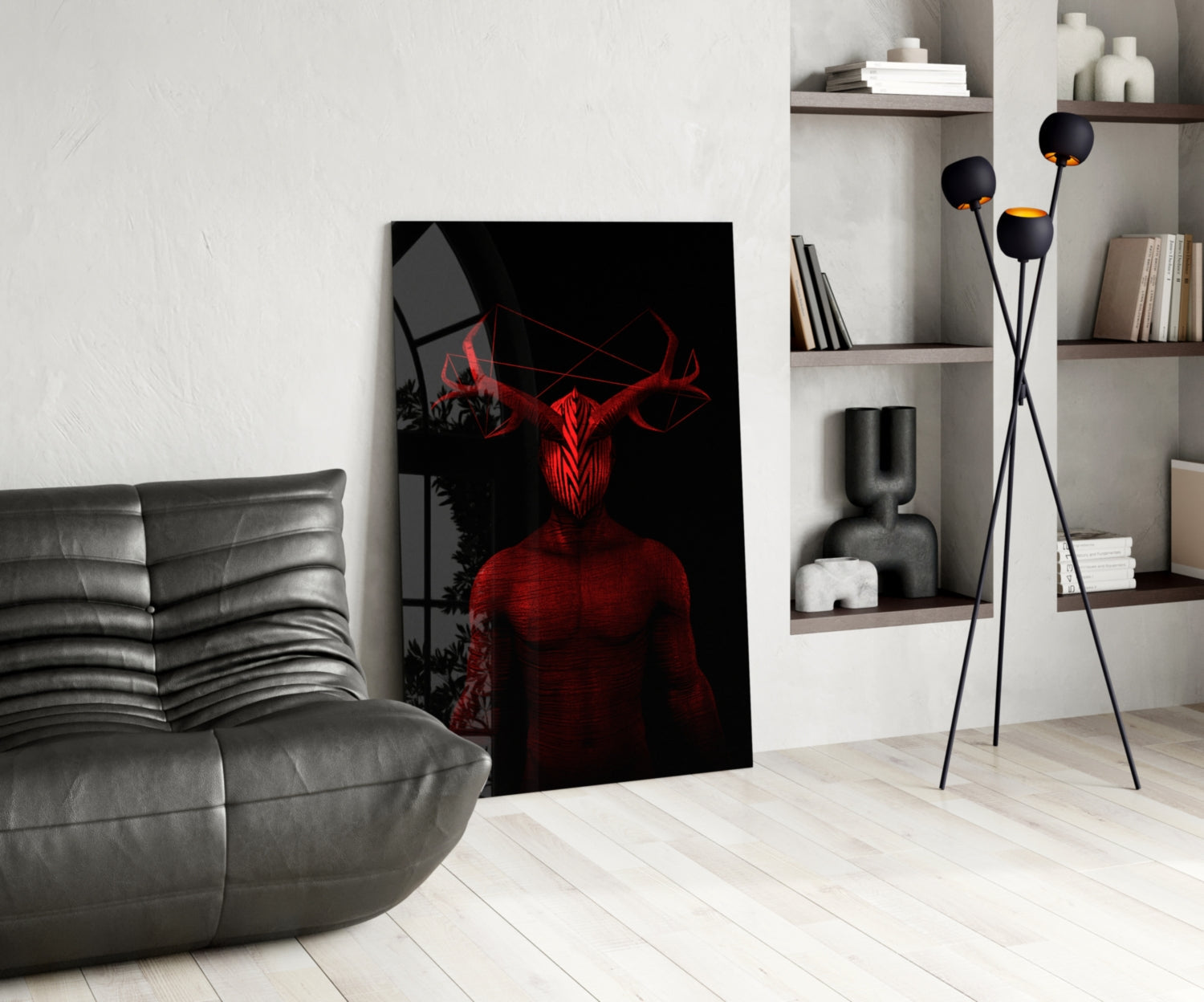 Dark red and black glass wall art depicting a horned demonic figure displayed in a modern living room with gray sofa and shelving.