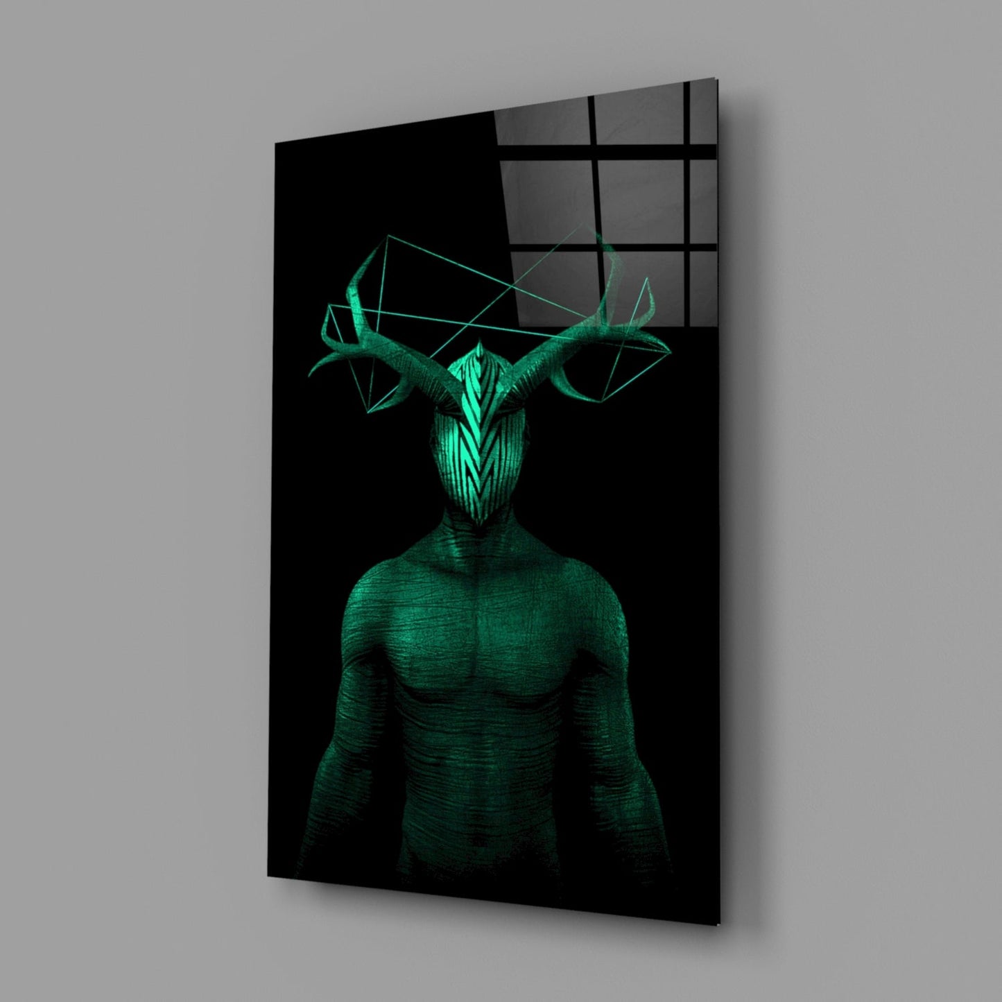 Glass wall art displaying a glowing green humanoid figure with geometric horns against black background, mounted at angle.