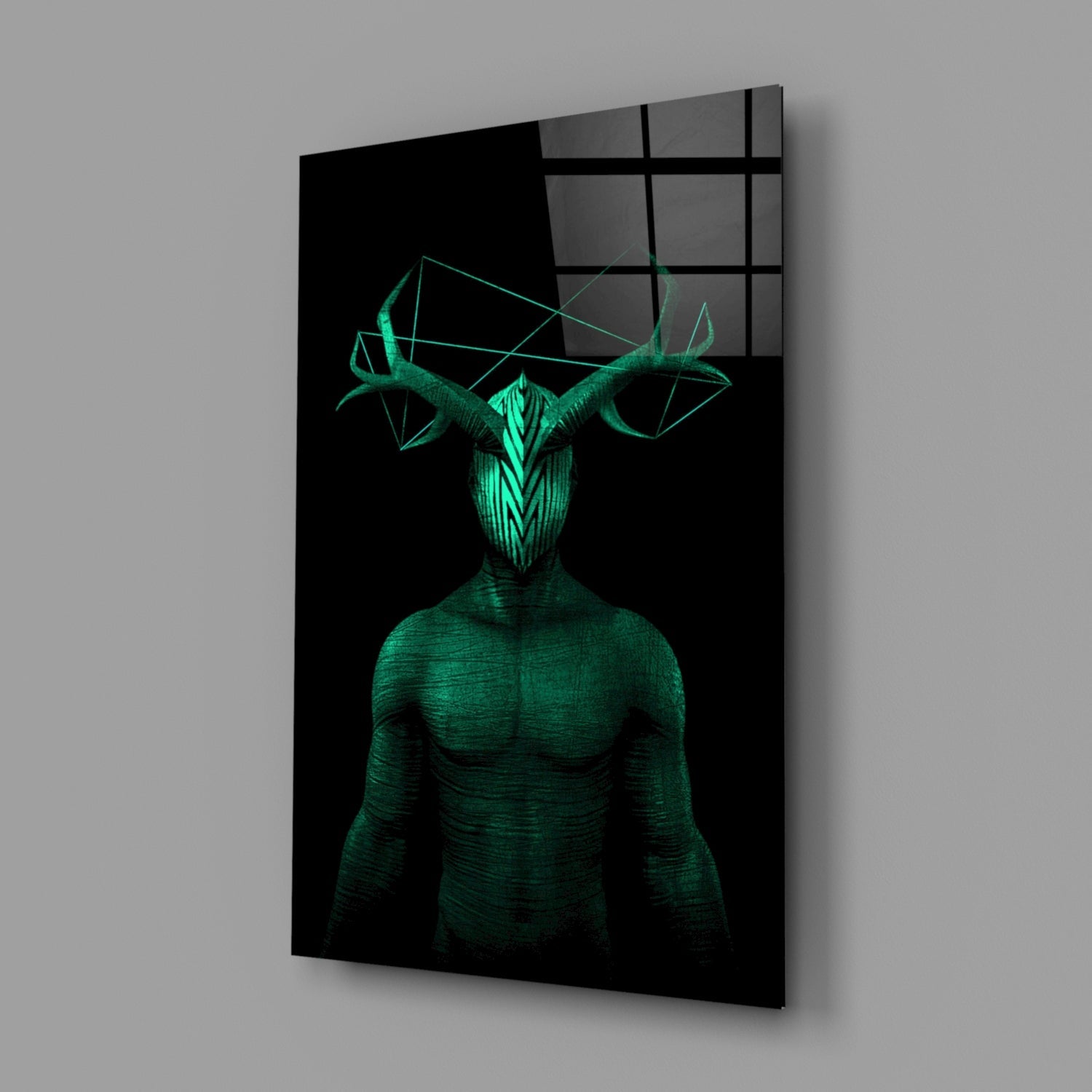 Glass wall art displaying a glowing green humanoid figure with geometric horns against black background, mounted at angle.