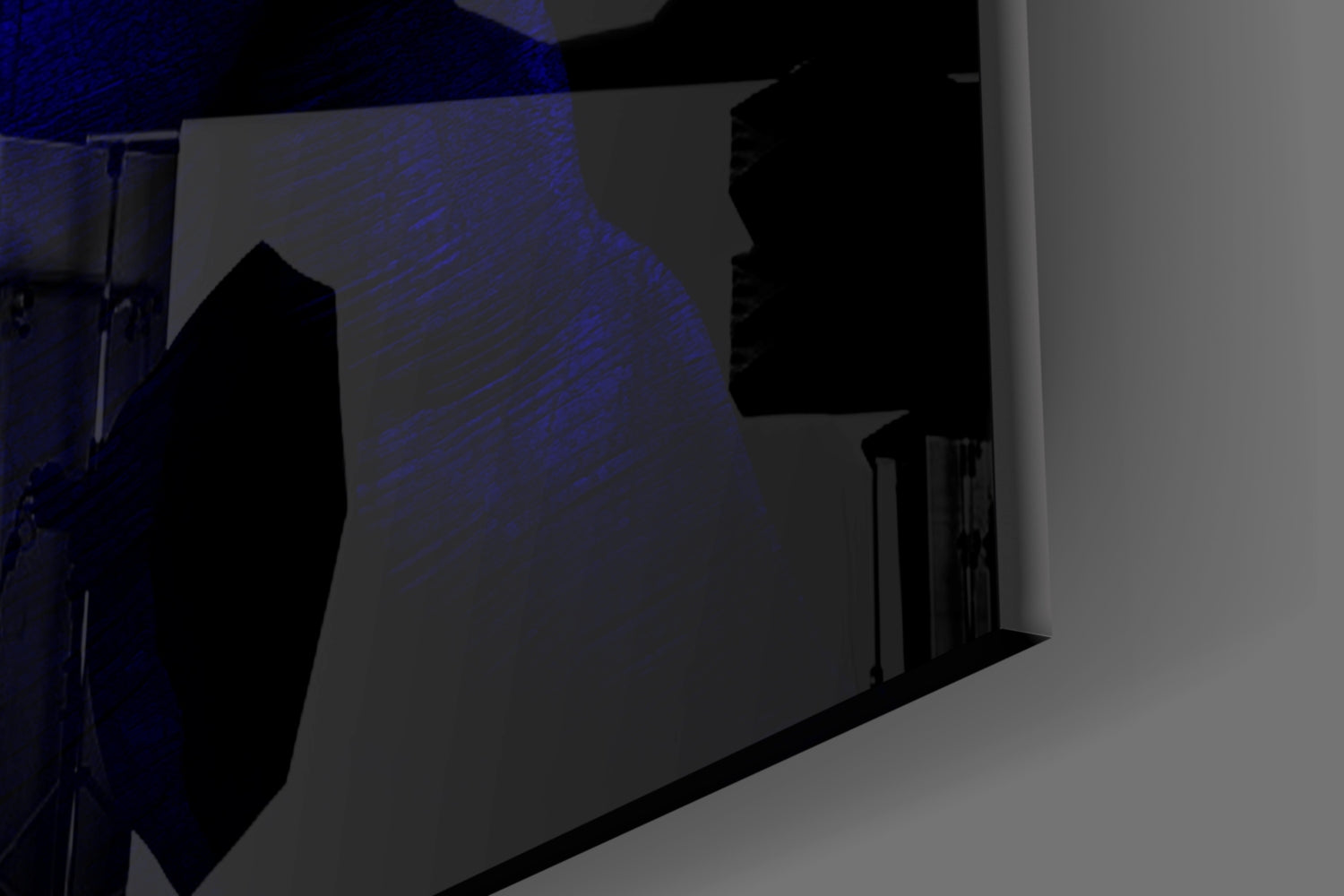 Silhouetted view of blue glass wall art installation mounted on white wall with blue ambient lighting.