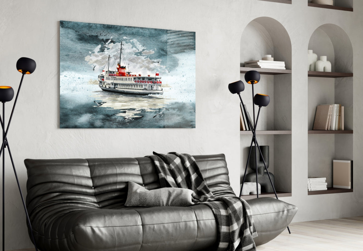 Modern living room with turquoise steamer ship glass wall art above black leather sofa beside white shelving unit.