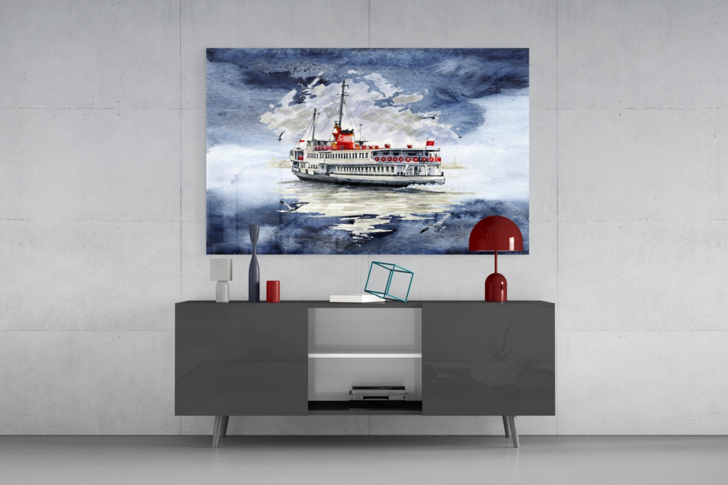 Glass wall art depicting a red and white steamer ship on blue water, displayed above a dark gray cabinet.