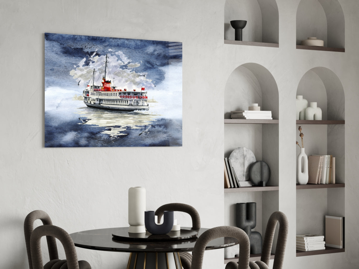 Steamer glass wall art depicting a red and white ferry boat on blue-grey water, displayed above a black round dining table in a modern interior.