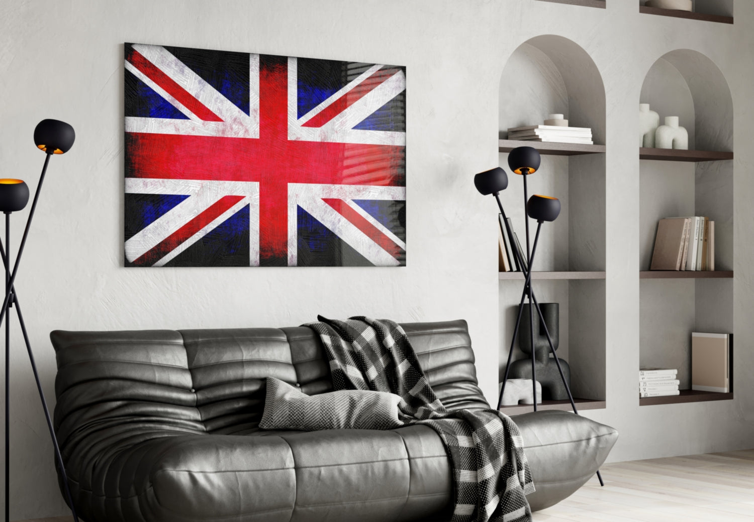 British flag glass wall art displayed above black leather sofa in modern living room interior with shelving and decorative accessories.