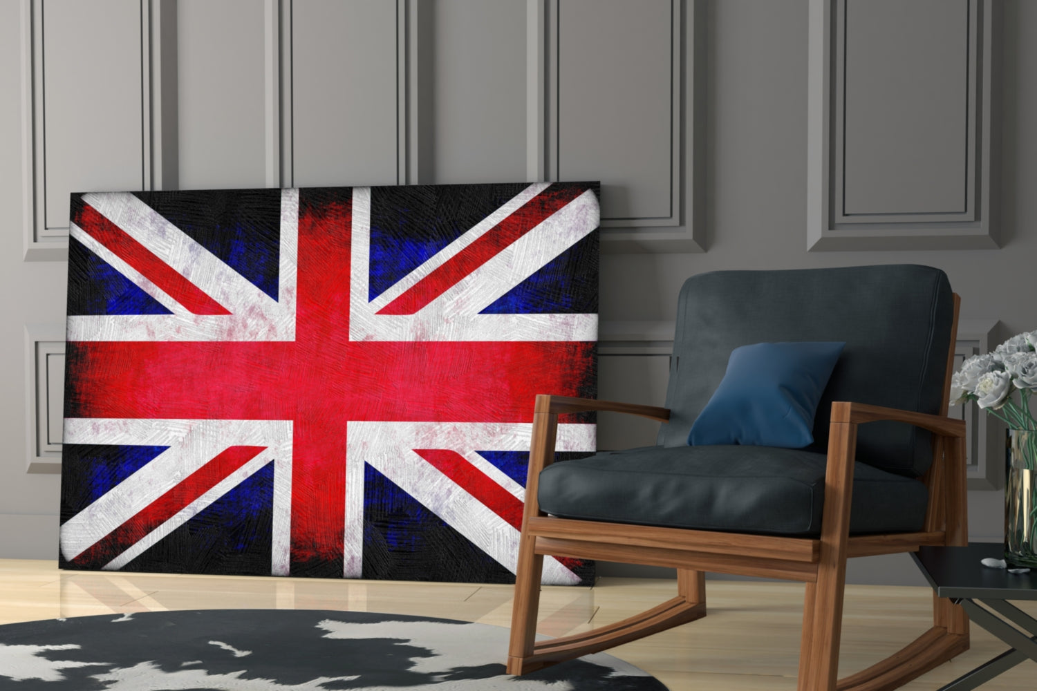 British flag glass wall art displayed on a light gray paneled wall beside a wooden rocking chair with black leather seat and blue cushion.