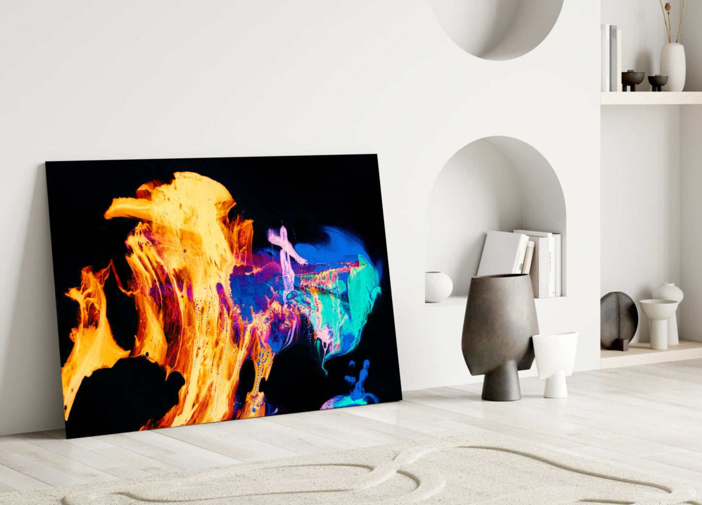 Vibrant thermal-style glass wall art leaning against white wall in minimalist room setting, showing colorful fire and blue hues.