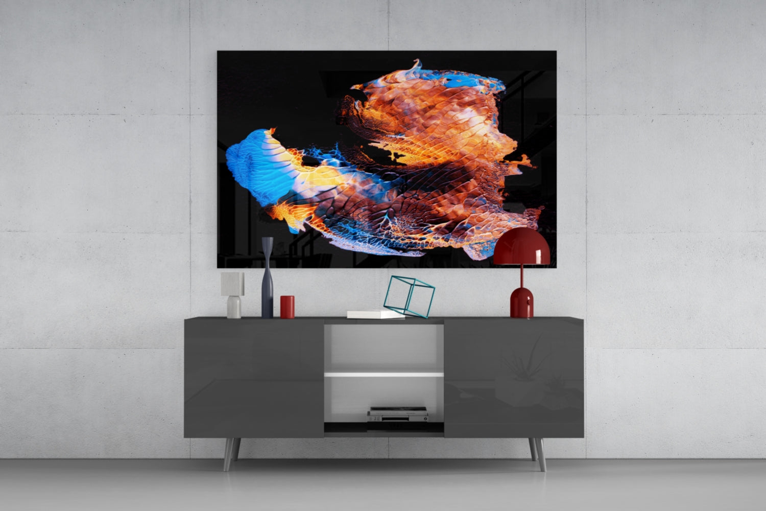 Modern living room displaying abstract glass wall art with orange, blue, and gold geometric shapes mounted above gray media console.