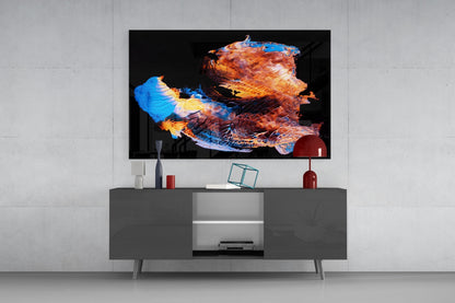 Modern living room displaying abstract glass wall art with orange, blue, and gold geometric shapes mounted above gray media console.