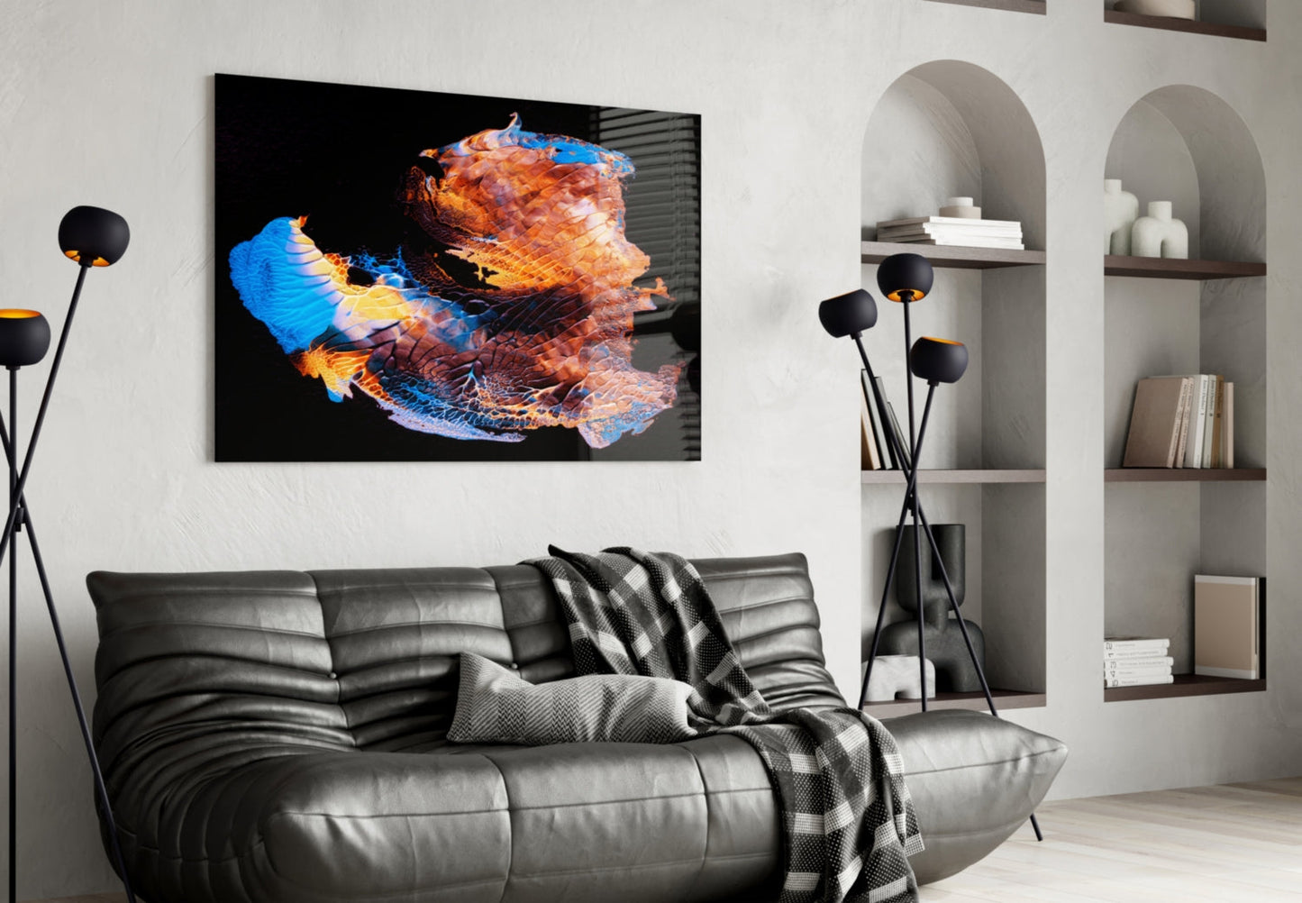 Modern living room with black leather sofa displaying abstract glass wall art featuring blue, orange, and red colorful brushstroke design above it.