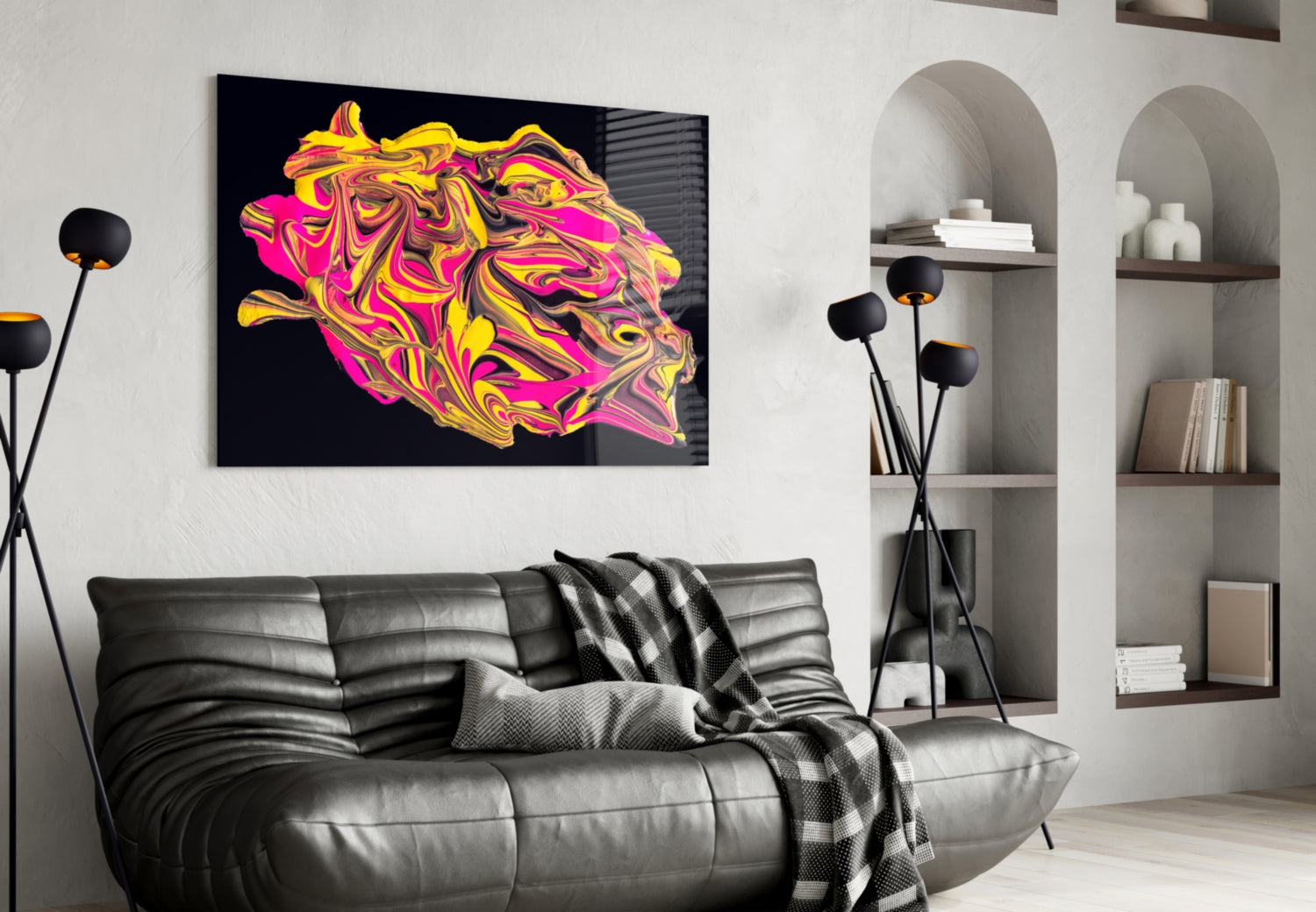 Vibrant yellow, pink, and magenta abstract swirled glass art displayed above a gray leather sofa in a modern living room.