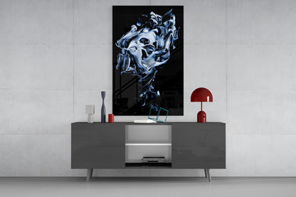 Modern living room setting with abstract blue and white swirling glass wall art displayed above a gray media console with red accents.