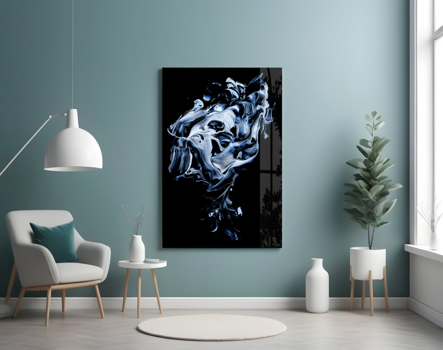 Abstract gray and blue swirling glass artwork displayed on teal wall above white chair in minimalist interior setting.