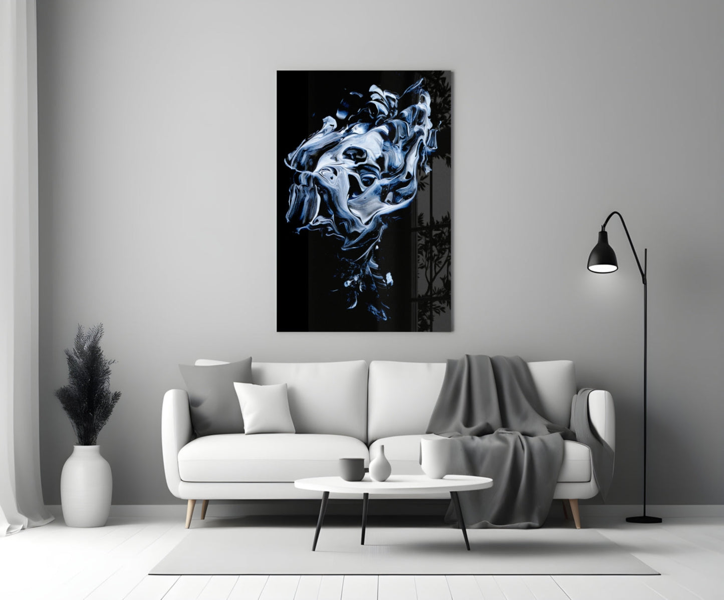 Abstract gray and blue swirling glass art displayed above white sofa in minimalist living room interior.