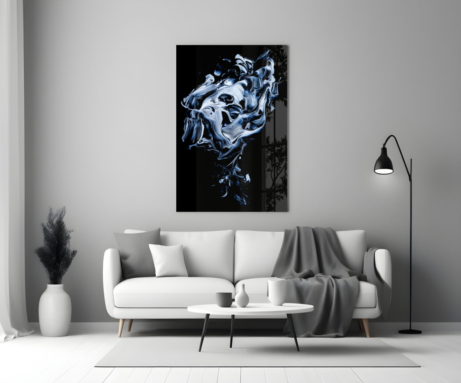 Abstract gray and blue swirling glass art displayed above white sofa in minimalist living room interior.
