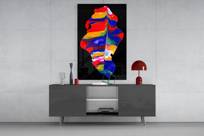 Colorful rainbow striped glass wall art displayed above a gray media console in a minimalist interior setting.