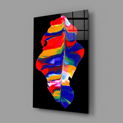 Colorful glass wall art panel displaying vibrant red, blue, yellow, and orange striped abstract form against black background.