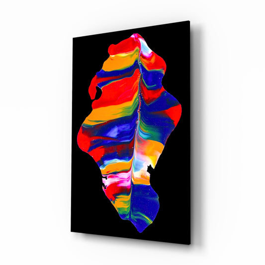 Angled view of a black-backed glass wall art panel displaying a colorful abstract form in red, blue, orange, yellow, and green stripes.