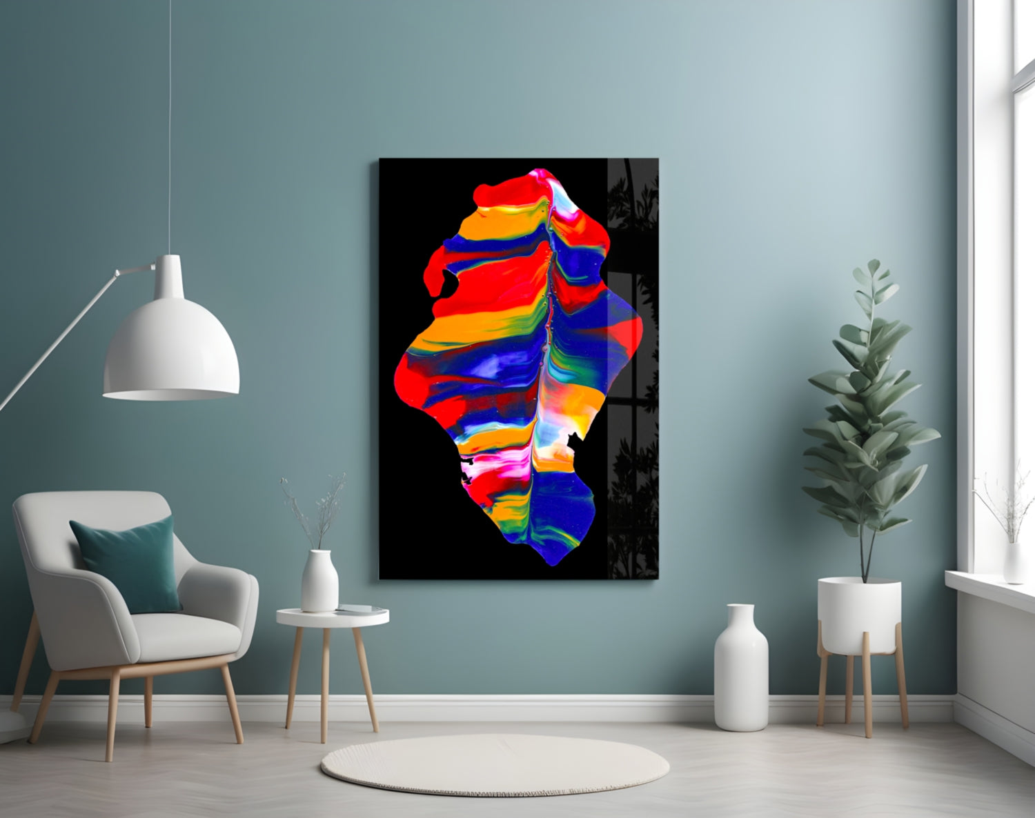 Colorful abstract glass wall art in vibrant rainbow hues displayed in a modern living room with teal walls, white furniture, and potted plants.