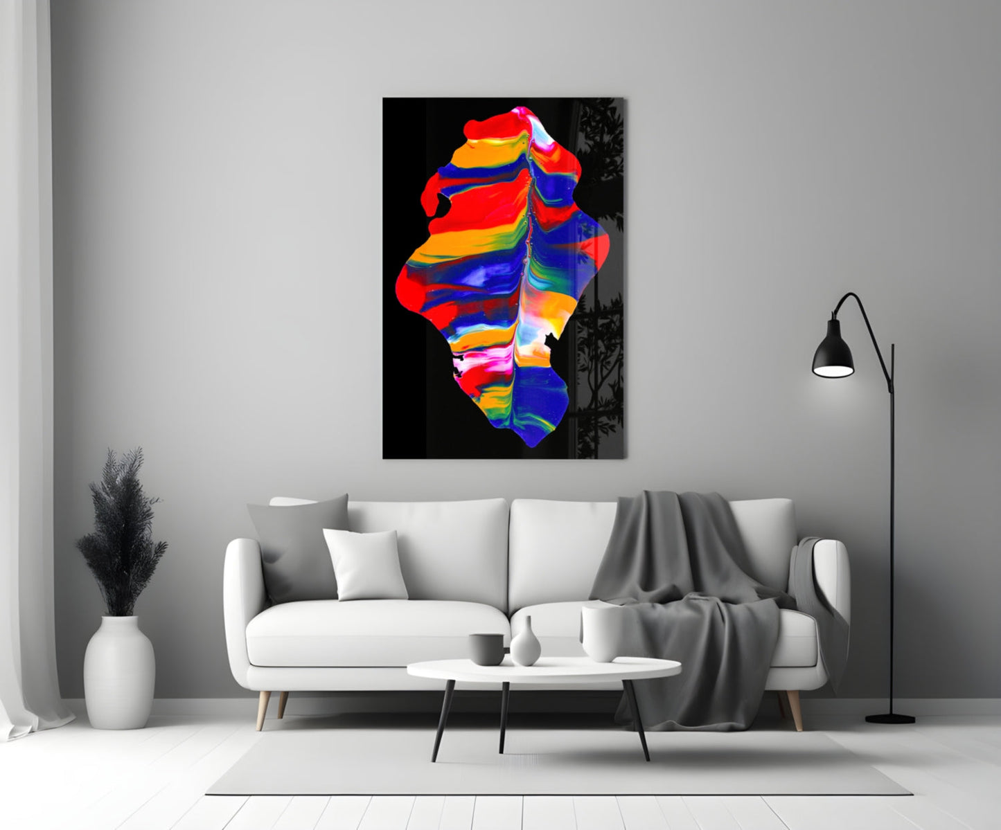 Colorful abstract glass wall art featuring vibrant rainbow stripes displayed above a white sofa in a modern living room.