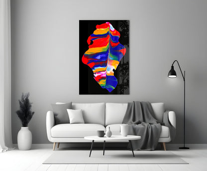 Colorful abstract glass wall art featuring vibrant rainbow stripes displayed above a white sofa in a modern living room.
