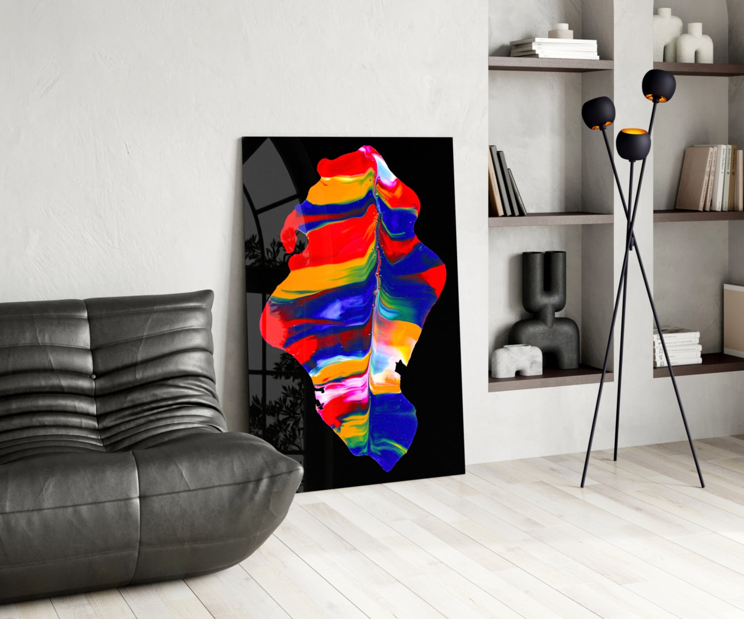 Colorful abstract glass art with red, blue, yellow, and orange stripes displayed in a modern living room next to a gray sofa and shelving unit.