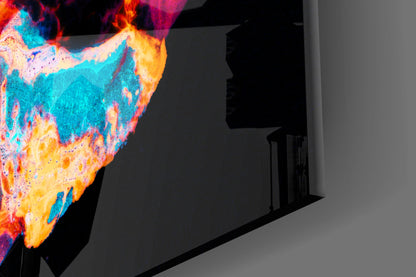 Vibrant multicolored glass art panel displaying swirling cyan, yellow, orange, and pink patterns mounted on interior wall.