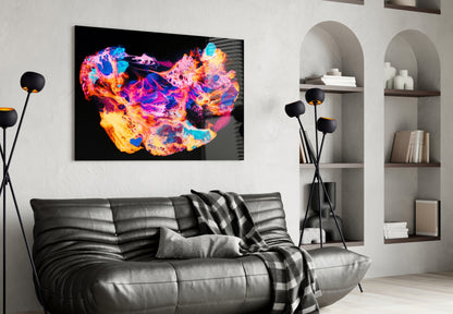 Vibrant thermal-map glass art displaying colorful heat zones in reds, oranges, and blues hung above a gray leather sofa in a modern living room.