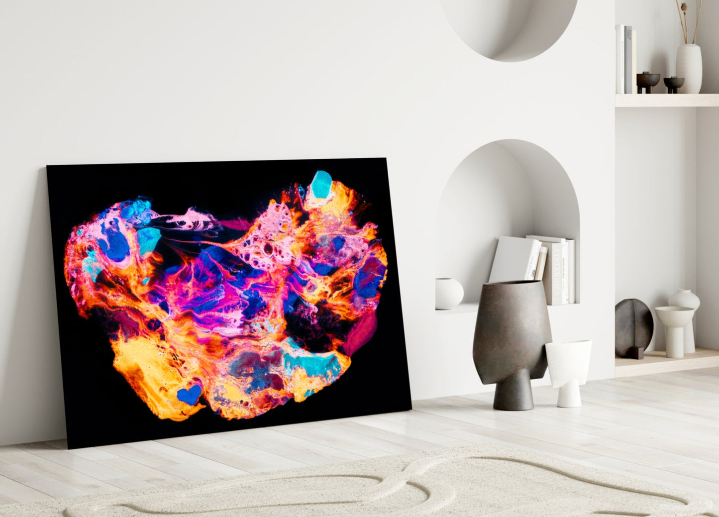 Vibrant abstract glass art with neon pink, blue, yellow, and orange swirls on black background, leaning against white wall shelf.