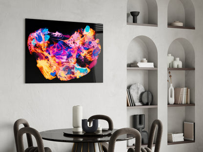 Vibrant neon heat-map style glass wall art depicting China in brilliant blues, pinks, oranges, and yellows displayed above a dining table.