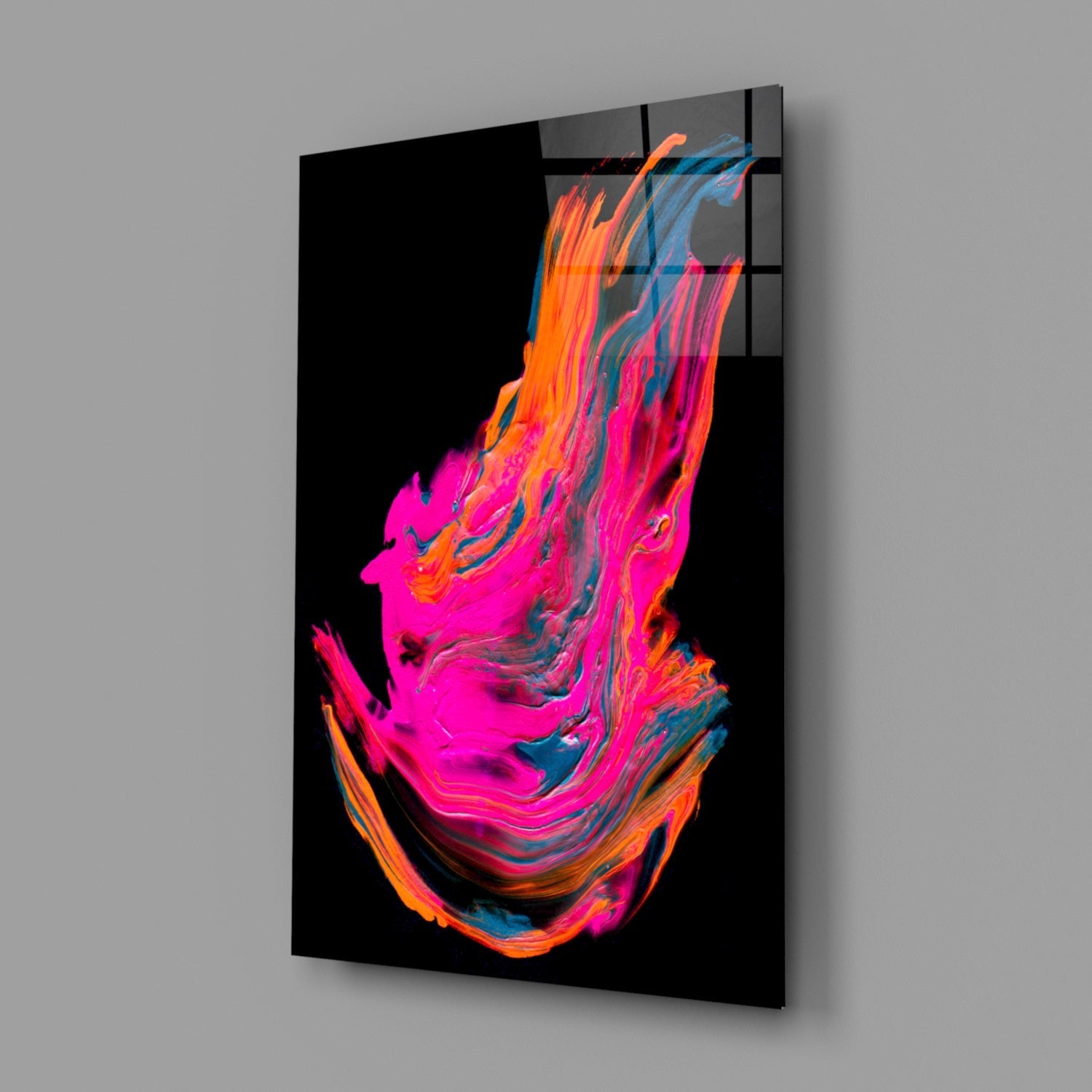 Angled product view of black glass wall art featuring vibrant neon pink, orange, and blue abstract swirling design against dark background.