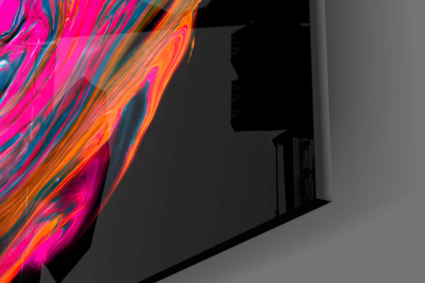 Vibrant neon pink and orange glass art panel with flowing striped pattern displayed against gray wall corner.