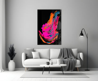 Vibrant abstract canvas with neon pink, orange, and blue swirling brushstrokes on black background, displayed above white sofa in modern living room.