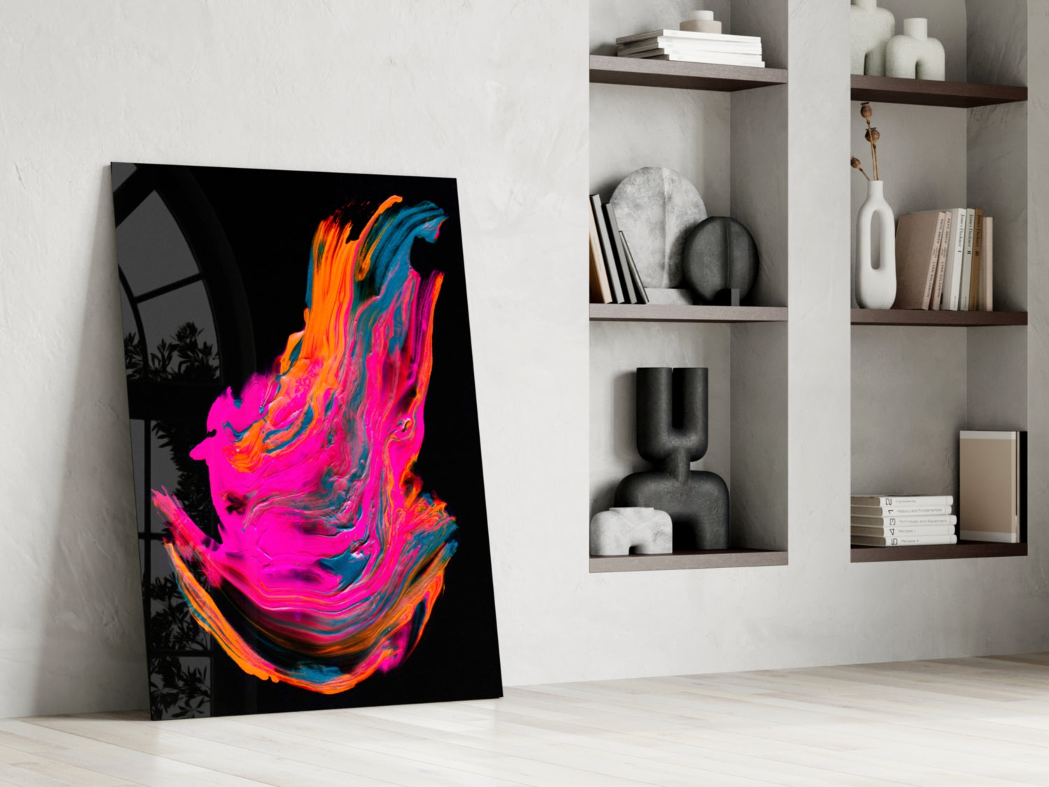 Vibrant abstract canvas with neon pink, orange, and blue swirling brushstrokes leaning against white wall beside shelving.