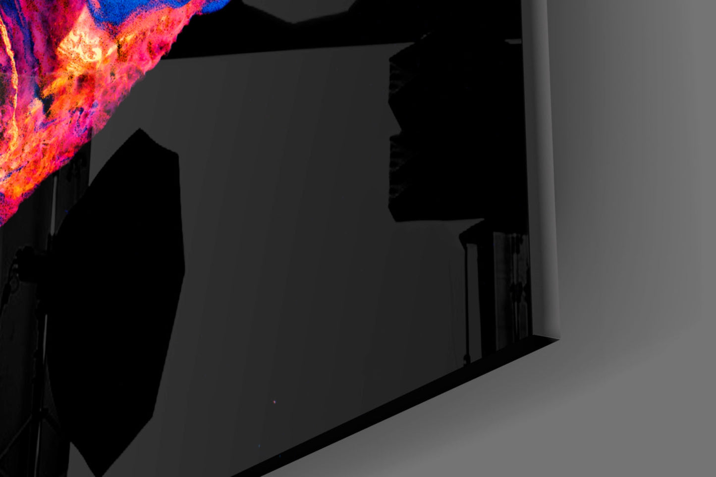 Vibrant colored lava glass wall art with magenta, orange, and yellow flames displayed in a modern interior space.