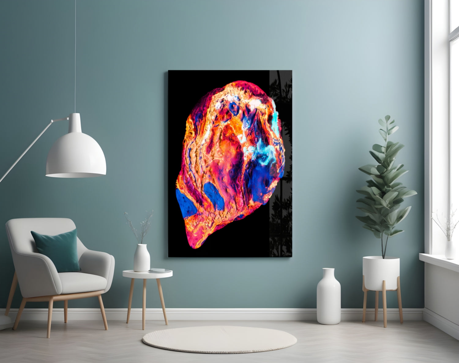 Colorful lava glass wall art featuring vibrant blues, oranges, reds, and yellows on black background, displayed in modern living room setting.