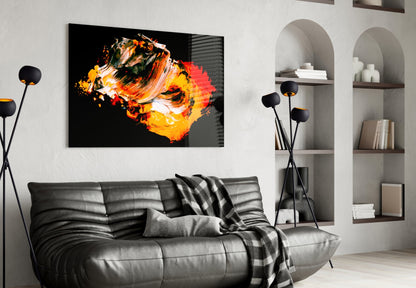 Modern living room with black leather sofa displaying vibrant orange and yellow abstract glass wall art above it.