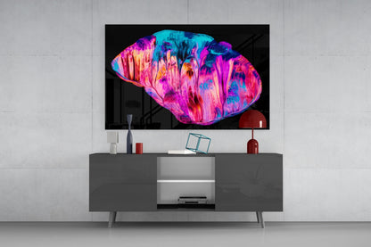 Vibrant pink and cyan abstract glass wall art displayed on mounted TV above gray media console in modern living room setting.