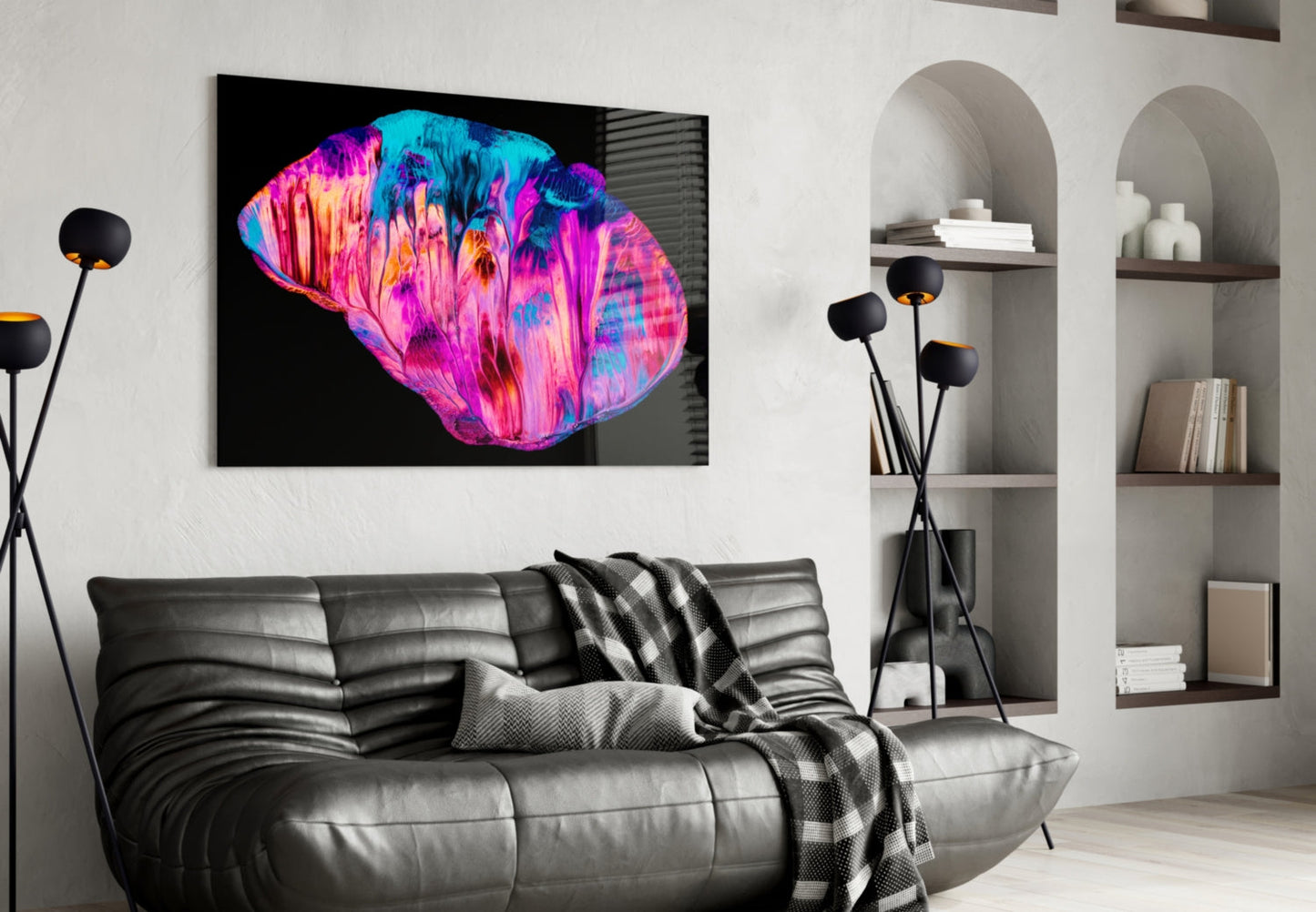 Vibrant pink and blue abstract glass wall art displayed above a gray leather sofa in a modern living room.