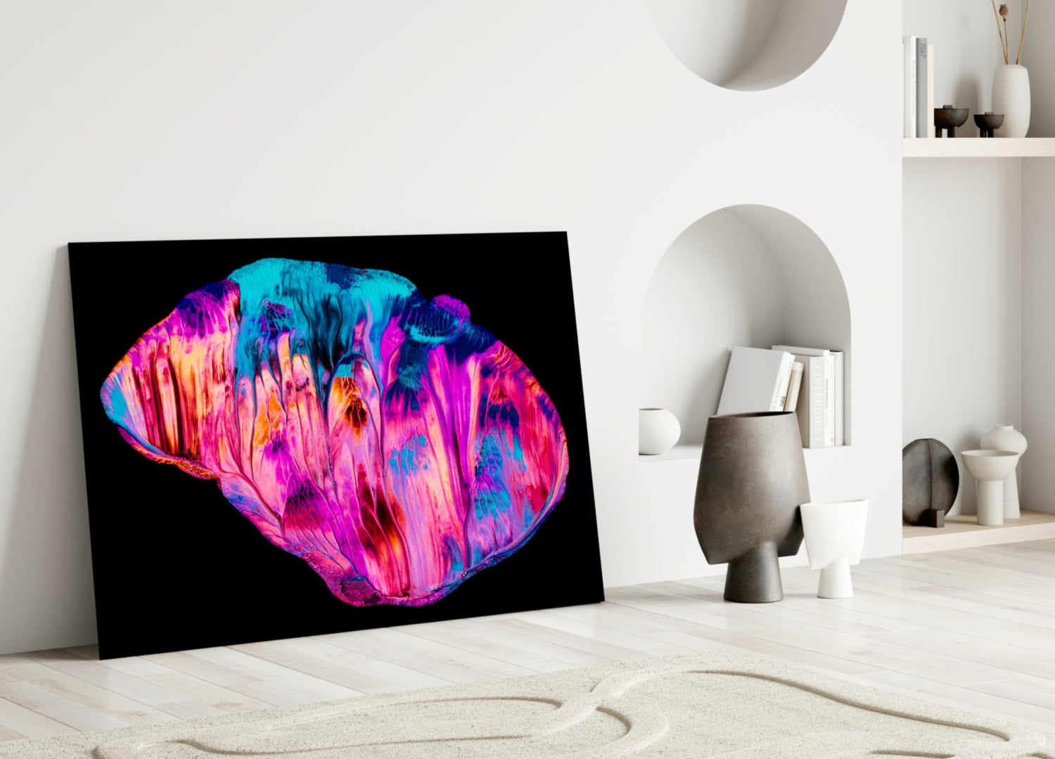 Vibrant neon pink and blue abstract glass art leaning against white wall in minimalist interior setting.