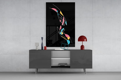Abstract Colorful Hands glass wall art displayed above gray media console, showing vibrant pink, yellow, and blue hand silhouettes on black background.