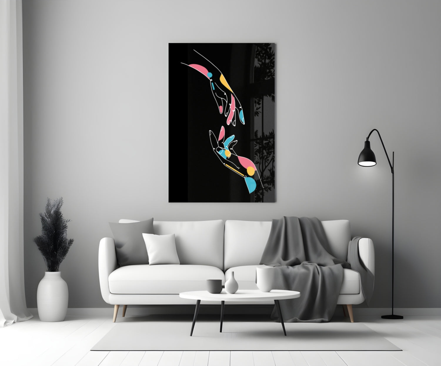 Colorful abstract hands glass wall art displayed above white sofa in modern living room interior.