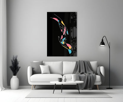 Colorful abstract hands glass wall art displayed above white sofa in modern living room interior.