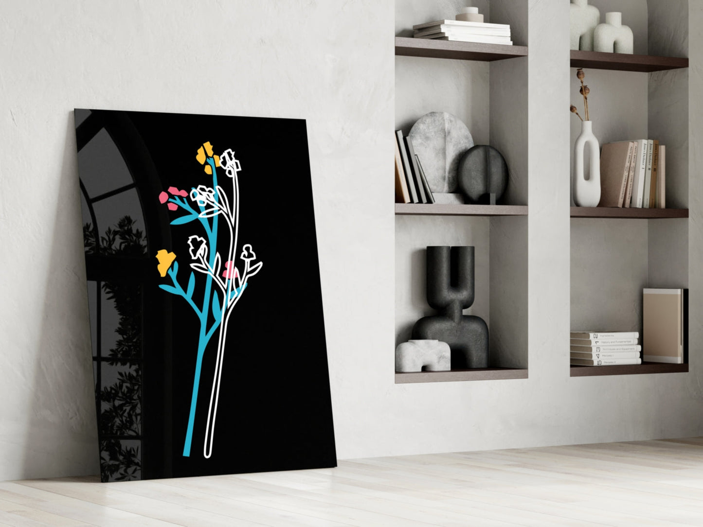 Black glass panel with colorful line-drawn flowers in yellow, pink, cyan, and white, leaning against white wall beside wooden shelving.